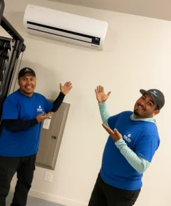 Two experienced technicians from Legend Air finish the installation of a ductless HVAC system