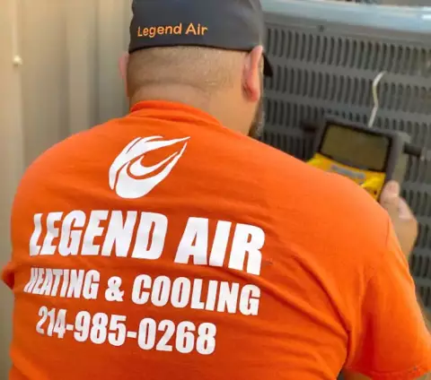 AC Repair technician doing a diagnostic test on an air conditioner.