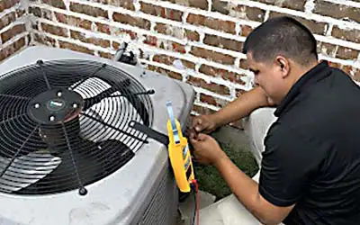 A Legend Air technician works on the outdoor AC unit for a customer in Little Elm